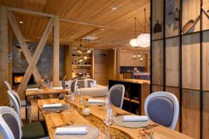 a dining room with wooden tables and chairs at Boutique hotel Vila Planinka in Zgornje Jezersko