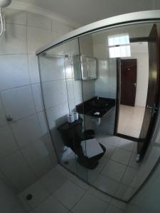 a small bathroom with a toilet and a sink at Casa Nui in Porto De Galinhas