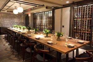 a long table in a room with wine bottles at Park South Hotel, part of JdV by Hyatt in New York