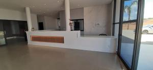 a lobby with a reception desk in a building at Hotel Alvorada - Trindade do Sul in Trindade