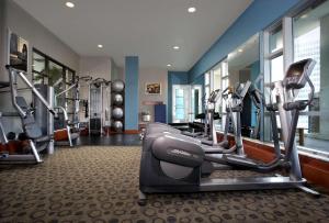 a gym with several tread machines in a room at Hyatt Regency Calgary in Calgary