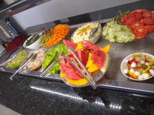 a buffet with a variety of different types of food at Hotel Alvorada - Trindade do Sul in Trindade +17 photos