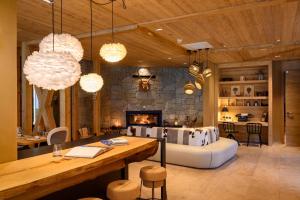 a living room with a couch and a fireplace at Boutique hotel Vila Planinka in Zgornje Jezersko