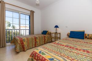 Ένα ή περισσότερα κρεβάτια σε δωμάτιο στο Blue Villa by ALGARVEMANTA