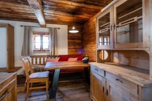 a living room with a wooden table and a couch at Bergappartements Pröll in Kleinarl +52 photos