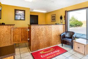 a waiting room with a bar with a chair at Econo Lodge near Missouri University of Science and Technology in Rolla