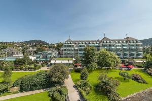 
a large building with a large lawn in front of it at Brenners Park-Hotel & Spa - an Oetker Collection Hotel in Baden-Baden
