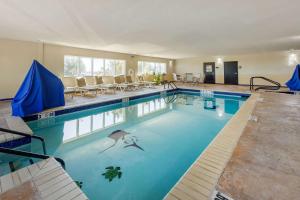 a large swimming pool with chairs in a building at Comfort Inn & Suites Perry I-35 in Perry