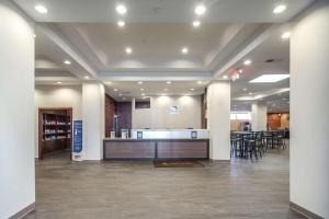 a lobby with a bar and some tables and chairs at Sleep Inn & Suites And Conference Center Downtown in Indianapolis