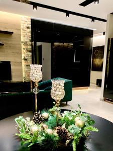 a table with two wine glasses and christmas decorations on it at ZLOTA Luxury Apartments in Warsaw