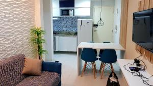 a small living room with a table and chairs at Porto de Galinhas - Muro Alto Condomínio Clube in Ipojuca