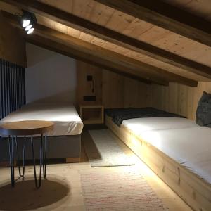 two bunk beds in a room with a table at Dorf Alm in Obergurgl