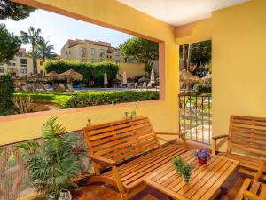 a balcony with two benches and a view of a resort at Apartment Dona Lola by Interhome in Sitio de Calahonda