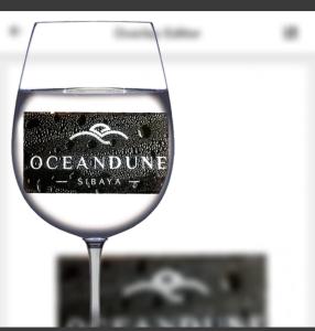 a glass of wine with a label on it at OCEANDUNES SIBAYA UMHLANGA in Sibaya