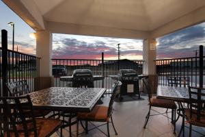 a patio with tables and chairs and a grill at Candlewood Suites Odessa by IHG in Odessa