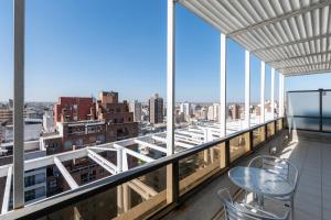 a balcony with a view of a city at AT Suites in Córdoba