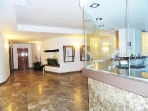 a lobby with a glass wall in a building at Novelty I in Salou +9 photos