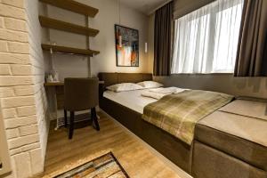 Postel nebo postele na pokoji v ubytování Belgrade Inn Garni Hotel