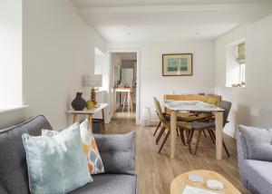 a living room with a couch and a table at Harewood Estate Cottages in Harewood