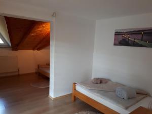 a bedroom with a bed and a painting on the wall at Apartman Ivana in Jajce
