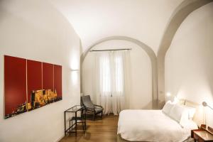 Ein Bett oder Betten in einem Zimmer der Unterkunft Il Loggiato by Wonderful Italy