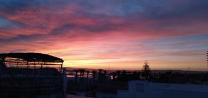 a sunset over a city with a sky at Dar Warda in Bizerte