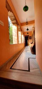 a living room with a wood floor and a room with a window at Durag Niwas Guest House in Jodhpur