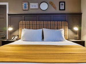 a bedroom with a large bed with two pillows at The Feathers Hotel in Ludlow +67 photos