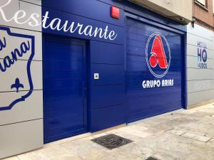 a pair of blue garage doors on a building at Hotel La Serrana, antiguo 40 Nudos in Avilés