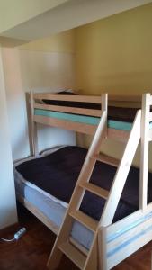 two bunk beds in a small room with a bed at Apartmani Nebrigic in Brzeće