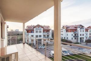 a balcony with a view of a parking lot at Grand Apartments - Neptun Park. in Gdańsk