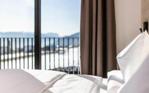 A bed or beds in a room at Aparthotel Panorama Living Dolomites