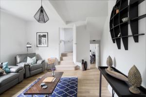 a living room with a couch and a table at Harewood Estate Cottages in Harewood