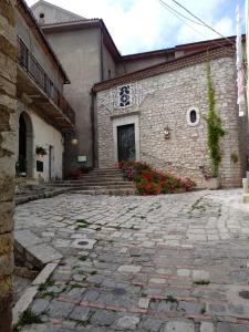a building with a stone walkway in front of it at Casa Palazzo ducale in Pietragalla