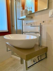 uma casa de banho com um lavatório branco num balcão em B&B Fortuny em Veneza