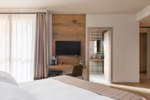 TV a/nebo společenská místnost v ubytování QC Room San Pellegrino
