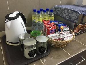 a counter with a tea kettle and a basket of food at ORKED BELLINA, 3 Bedroom apartment, near Pantai Batu Burok, NETFLIXWIFIYOUTUBE in Kuala Terengganu +10 photos
