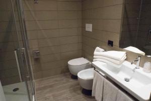 a bathroom with a toilet and a sink and a shower at Hotel San Giovanni Roma in Rome