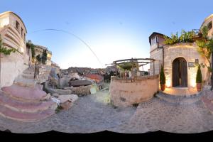 a group of buildings with stairs in a town at Dokya Hotel in Ürgüp