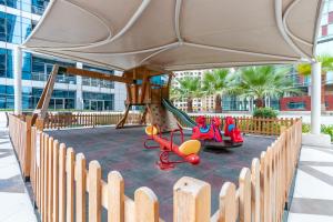 a playground in a building with a swing set at Quintessential Quarters - Instagram-worthy Views in Dubai