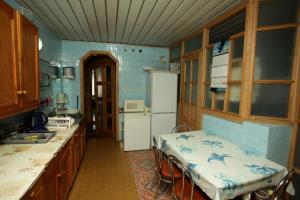 a kitchen with a refrigerator and a table in it at Vila Pas Justiną in Palanga