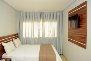 מיטה או מיטות בחדר ב-Tapajos Palace Hotel