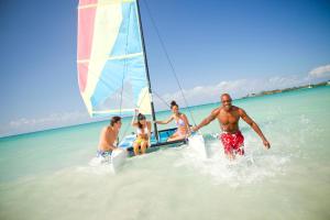 a group of people on a sail boat in the water at Couples Negril in Negril