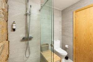 a bathroom with a glass shower with a toilet at YOUROPO - Ribeira Gaia in Vila Nova de Gaia +17 photos