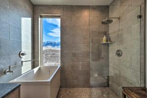 a bathroom with a tub and a shower with a window at Secluded Paradise Valley Retreat with Stunning Views in Livingston +28 photos