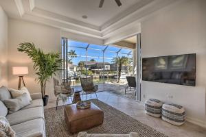 a living room with a couch and a tv at Luxury Island Oasis with Pool and Dock, 1 Mi to Beach! in Marco Island