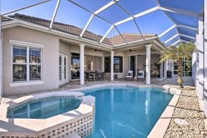 a home with a swimming pool and a house at Luxury Island Oasis with Pool and Dock, 1 Mi to Beach! in Marco Island