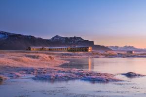 a building sitting on the side of a body of water at Hotel Langaholt in Langaholt