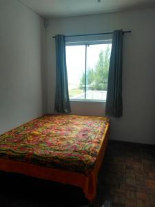 En eller flere senge i et værelse på Residencial Fênix