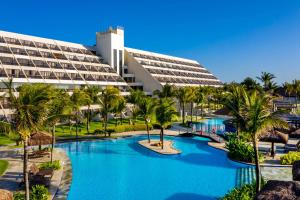 - une vue sur un complexe avec une piscine et des palmiers dans l'établissement Wish Natal, à Natal